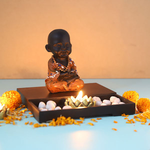 Cute Buddha Monk Sitting With T Light Holder And Pebbles