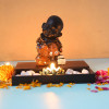 Buddha Monk Sitting With T Light Holder And Pebbles
